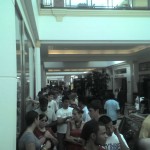 A crowd of people waiting in a mall